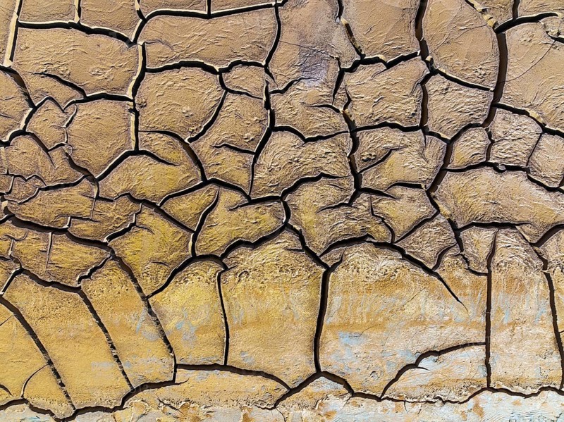 Mineral-rich cracked earth at the bank of the Rio Tinto (Red river), aerial view, drone shot, Huelva province, Andalusia, Spain, Europe