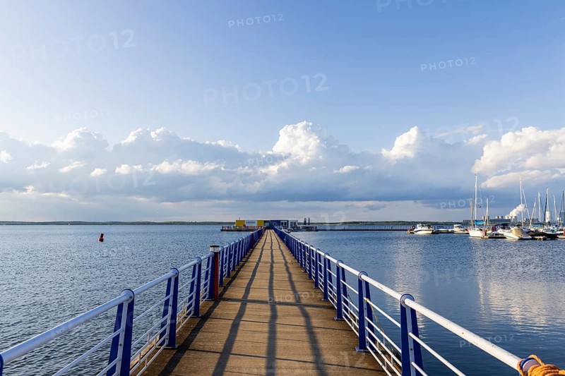 Bärwalder See Landscape Park, post-mining landscape, remnant hole of the Bärwalde open-cast mine, silhouette of the Boxberg power station, Klitten harbour, pier, yachts, Klitten, Saxony, Germany, Europe