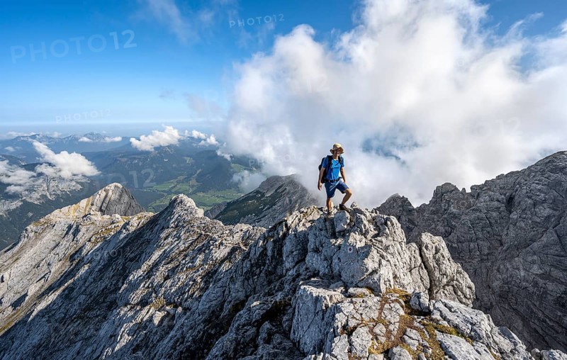 Mountaineer on a rocky narrow mountain path with mountain panorama, mountain tour to the summit of the Hochkalter, Hochkalter crossing, Berchtesgaden Alps, Bavaria, Germany, Europe