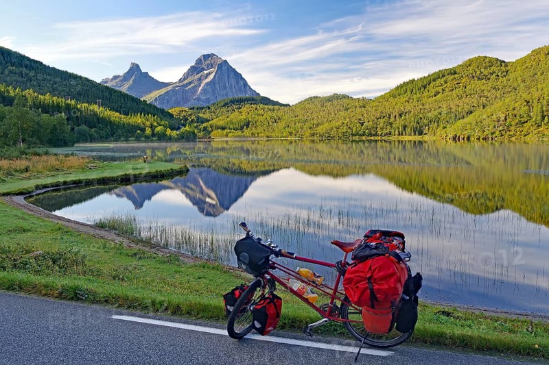 Packed touring bike in front of mountain lake and steep mountains, no cars, bicycle trip, FV !7, Kystriksveien, Nordland, Norway, Europe