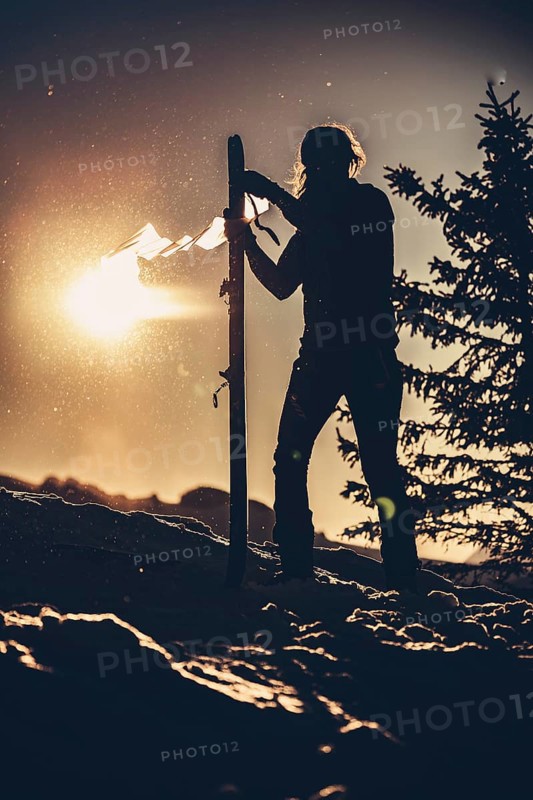 A woman's ski tour at sunrise on the Tegelberg in the Allgäu in the Ammergebirge, Bavaria, Germany, Europe