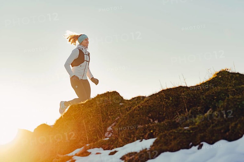 Trail running in autumn on the Jochberg on Lake Walchensee against the wonderful backdrop of the Alps, Bavaria, Germany, Europe