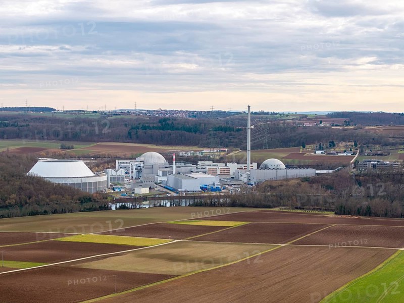 The decommissioned Neckarwestheim nuclear power plant lies in the middle of vast fields and forests under a cloudy sky, Neckarwestheim, Baden-Württemberg, Germany, Europe