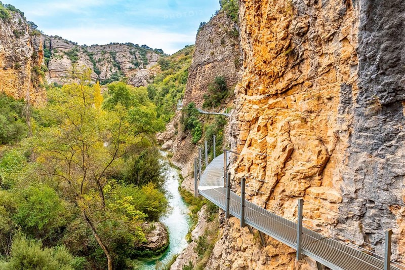 Metal walkways on the wall of the path next to the Vero River in Alquezar. Pyrenees