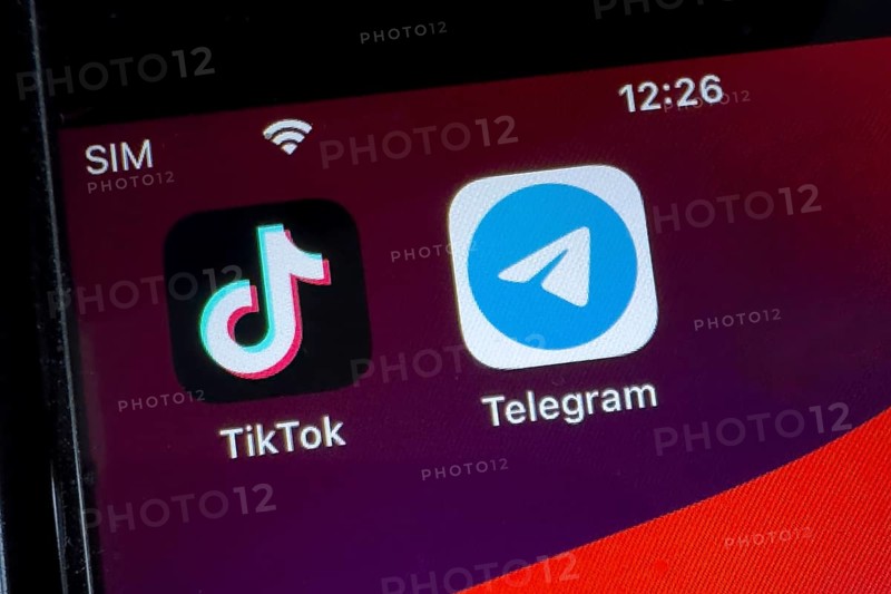 App icons from chat programmes free instant messaging service on the left from China TikTok and on the right Russian-developed messenger Telegram on smartphone, international