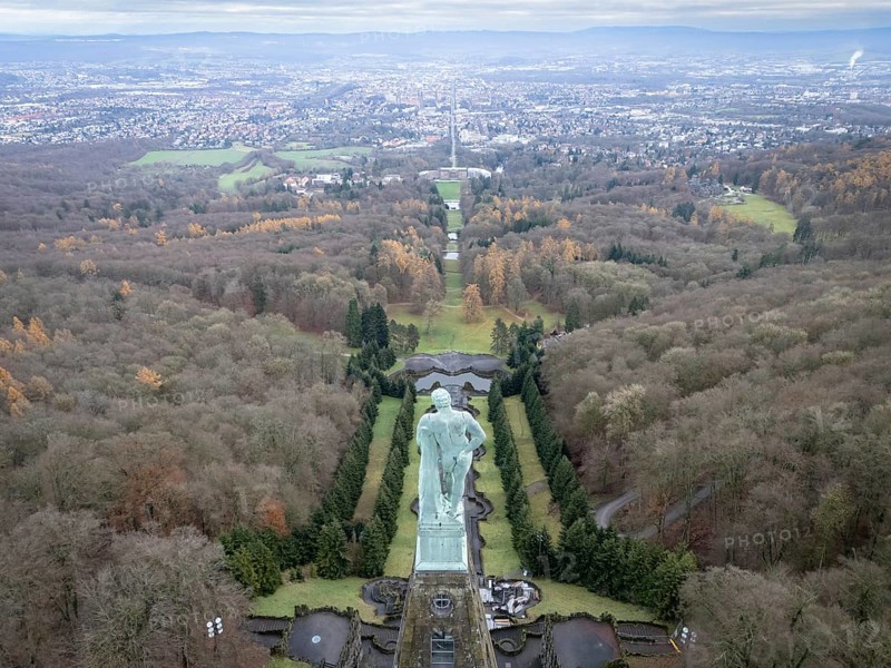 Copper statue of Hercules in Bergpark Wilhelmshöhe with a view over Wilhelmshöhe Palace and Wilhelmshöher Allee to Kassel city centre, Bad Wilhelmshöhe, Kassel, Hesse, Germany, Europe