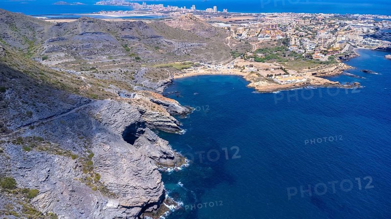 Aerial view of la manga del mar menor with its crystal clear turquoise waters gently lapping against the rocky coastline near cala reona