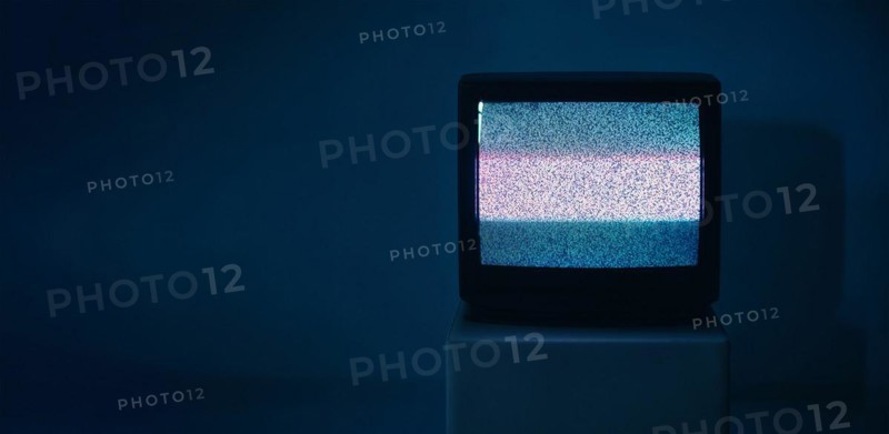 No TV signal on old television with copy space on dark background. Interference, television noise. Glitch Error. Video Damage