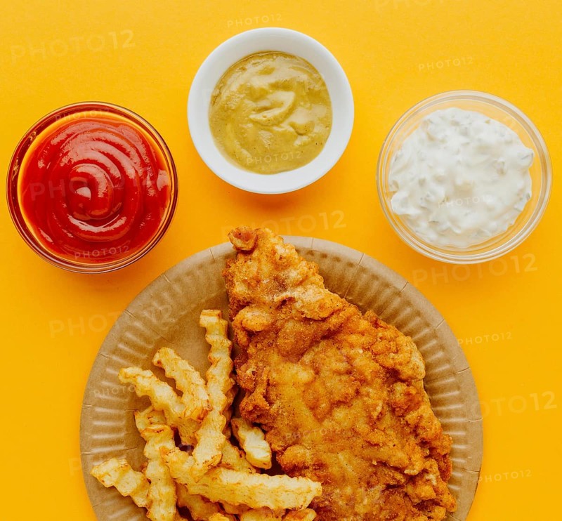 Top view fish chips plate with sauces