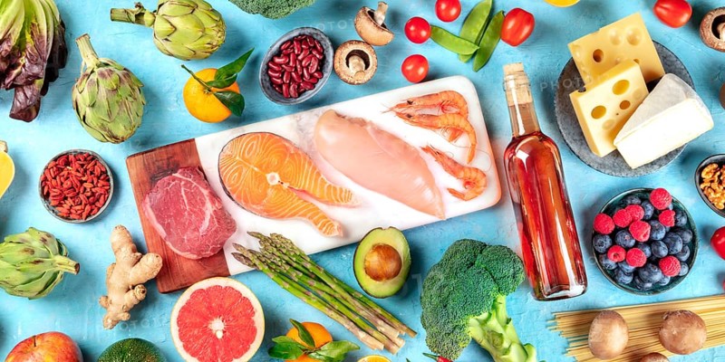 Food, overhead panorama on a blue background. Meat, fish, seafood, poultry, wine, cheese, mushrooms, pasta, nuts, fruits and vegetables, a variety of healthy organic products