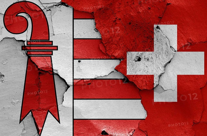 Flags of Jura canton and Switzerland painted on cracked wall
