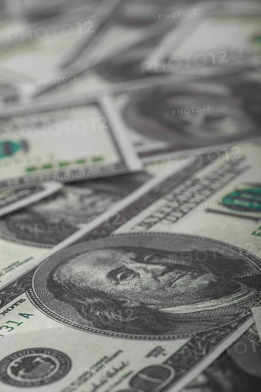 One hundred US dollars bills pile. Selective focus