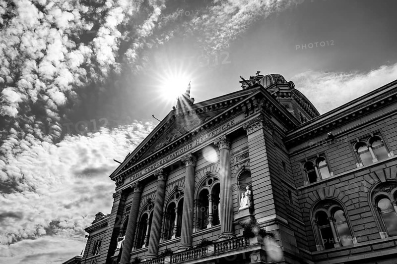 Beautiful Bundeshaus Parliament Building or Federal Palace in a Sunny Day with Sunbeam and Lens Flare in City of Bern, Canton Bern, Switzerland.