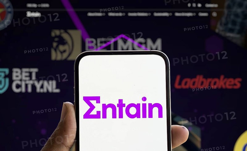 Dhaka, Bangladesh- 28 Nov 2024: Entain logo is displayed on smartphone.Entain plc is an international sports betting and gambling company