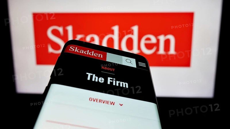 Stuttgart, Germany, 12-17-2023: Mobile phone with website of US law firm Skadden, Arps, Slate, Meagher and Flom LLP in front of logo. Focus on top-left of phone display, Europe