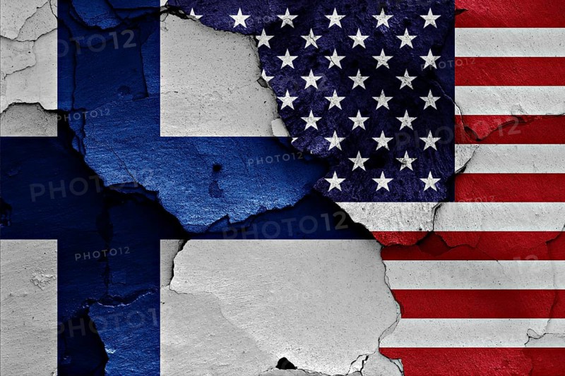 Flags of Finland and USA painted on cracked wall