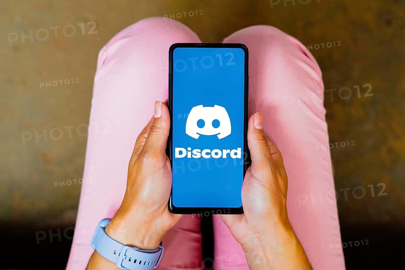 In this photo illustration, the Discord logo is displayed on a smartphone screen
