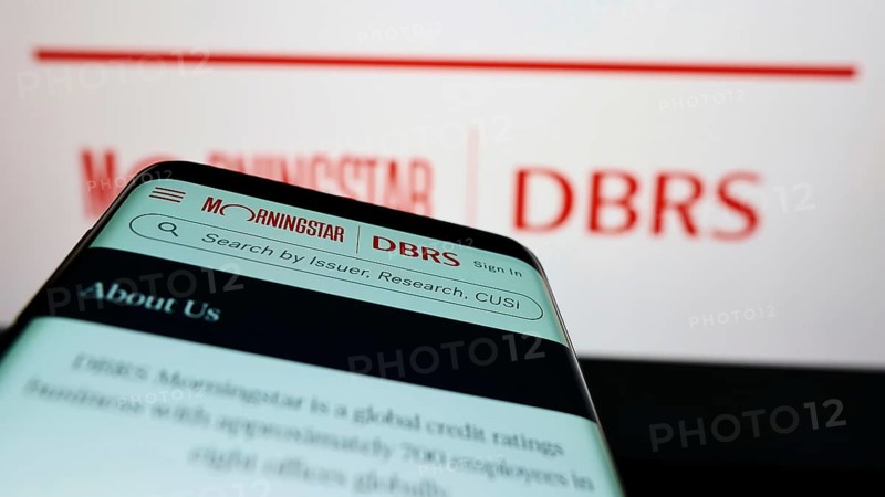 Stuttgart, Germany, 03-06-2022: Mobile phone with webpage of Canadian credit rating company DBRS Morningstar on screen in front of logo. Focus on top-left of phone display, Europe
