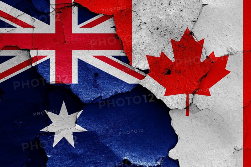Flags of Australia and Canada painted on cracked wall