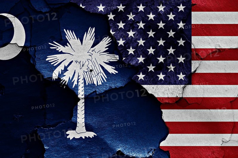 Flags of South Carolina and USA painted on cracked wall