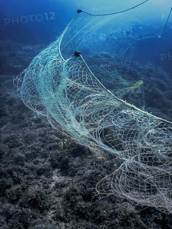 A fishing net underwater fixed on the seabed, deep water