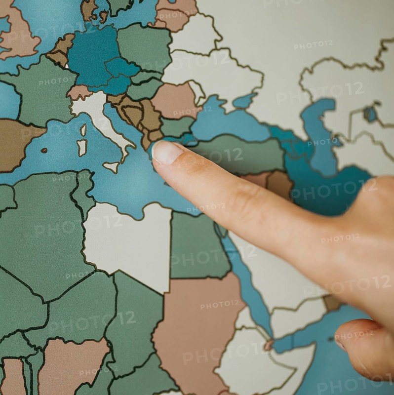 Person pointing europe map