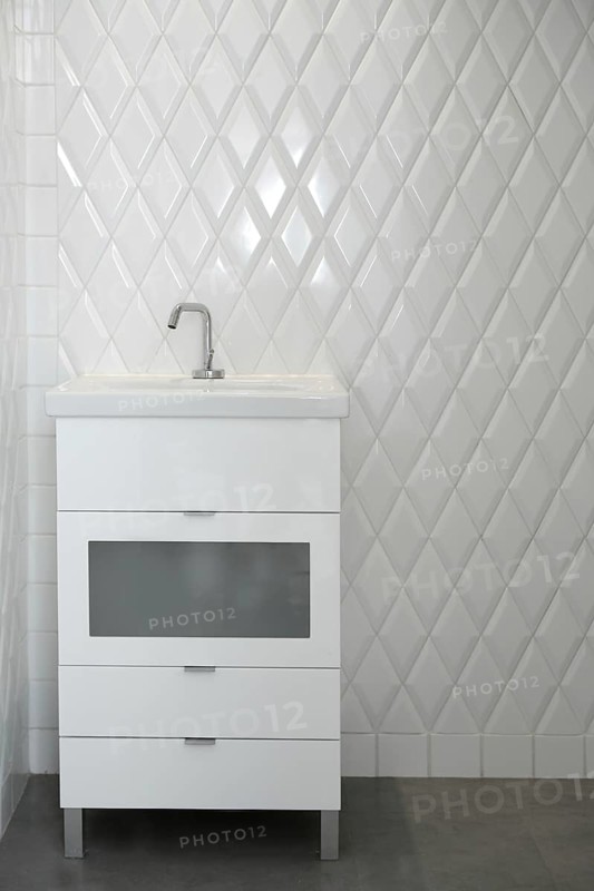 Toilet sink in a white room diamond shape tiles modern vintage bathroom
