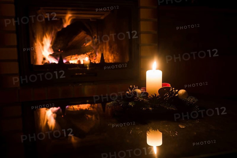 Christmas floral decoration in front of firepace.