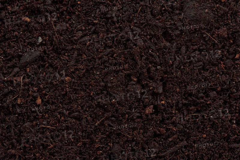 Organic potting soil mix enriched with compost abstract background texture closeup of particles