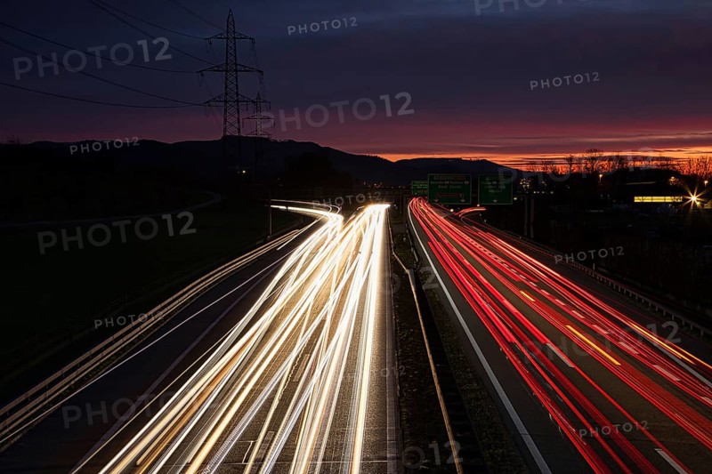 Long exposure of an illuminated motorway at night with disappearing light traces of vehicles, Kaiseraugst, Canton Aarau, Switzerland, Europe