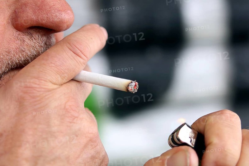 Man lights a cigarette