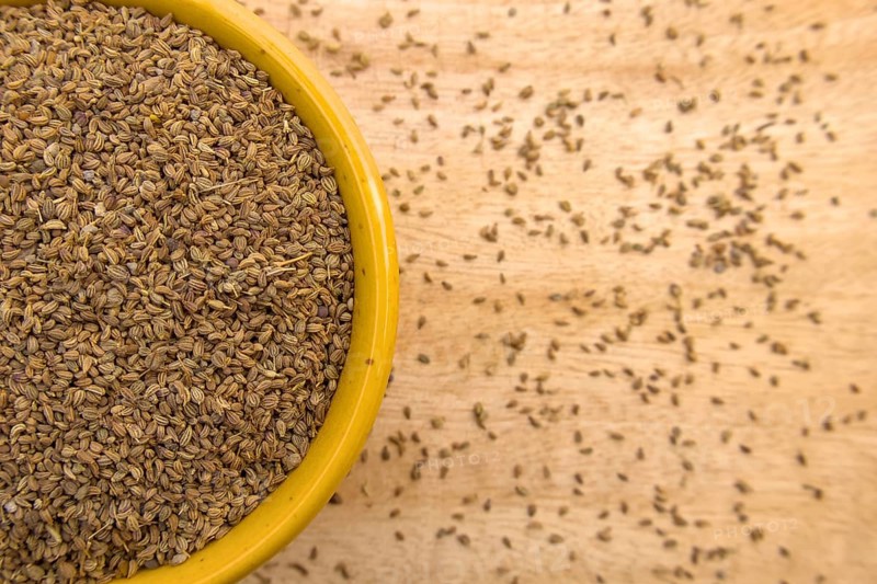Top View of Ajwain, Carom Seeds, Thymol Seeds, Bishop's Weed in a Yellow Bowl, Closeup