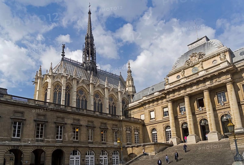 Sainte-Chapelle towers over the buildings of the Palais de Justice. Paris, France, Europe