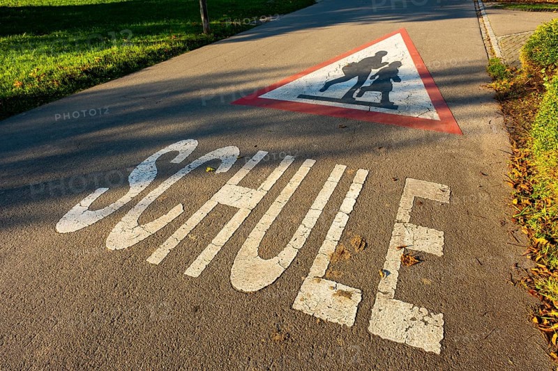 Triangular sign with children and the word SCHOOL on a street in front of the village school, Leimbach, Thurgau, Switzerland, Europe
