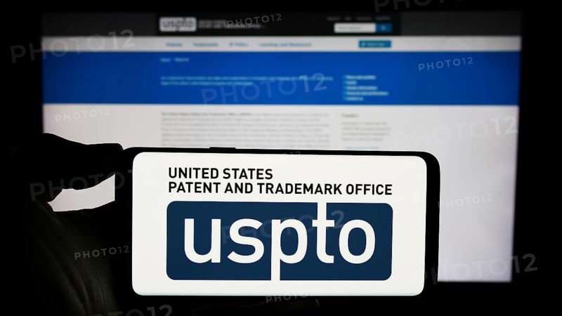 Stuttgart, Germany, 10-29-2023: Person holding smartphone with logo of agency United States Patent and Trademark Office (USPTO) in front of website. Focus on phone display, Europe