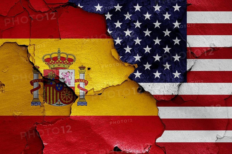Flags of Spain and USA painted on cracked wall
