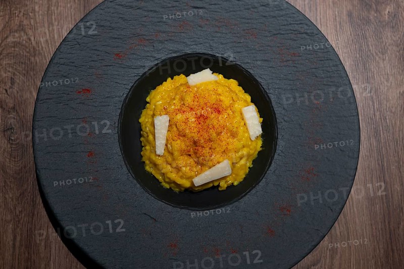 Elegant Plate with Risotto alla Milanese with Saffron and Parmesan Cheese in Lugano, Ticino, Switzerland, Europe