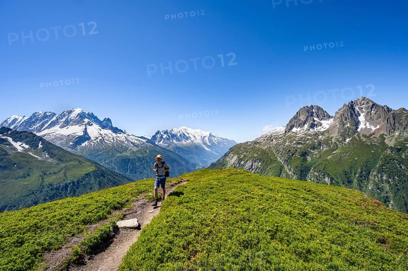 Mountaineer on hiking trail, mountain panorama with glaciated mountain peaks, Aiguille Verte with Aiguille du Midi and Mont Blanc, hike to Aiguillette des Posettes, Chamonix, Haute-Savoie, France, Europe