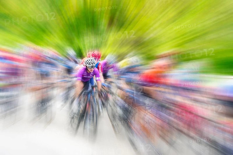 Cyclist in sportswear and helmet riding at high speed on a road, race, the motion blur emphasises the speed, Stuttgart, Baden-Württemberg, Germany, Europe