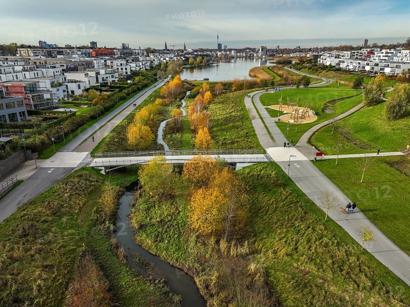 Dortmund, North Rhine-Westphalia, Germany, Phoenix Lake, front of the renaturalised Emscher. The river has been transformed into a near-natural body of water, flood protection and biodiversity through newly designed floodplains. A former industrial wasteland of 99 hectares was transformed into residential, work and leisure areas and 24 hectares of lake surface. In the event of heavy rainfall, the lake acts as a rainwater retention basin. Following the construction of a parallel sewer, the Emscher is now free of wastewater, having previously been an open, above-ground wastewater sewer, combined sewer with surface water and wastewater. The Phoenix Lake, a showcase project for structural change, is an artificial lake on the site of the former Phönix Ost steelworks in Dortmund's Hörde district, Europe