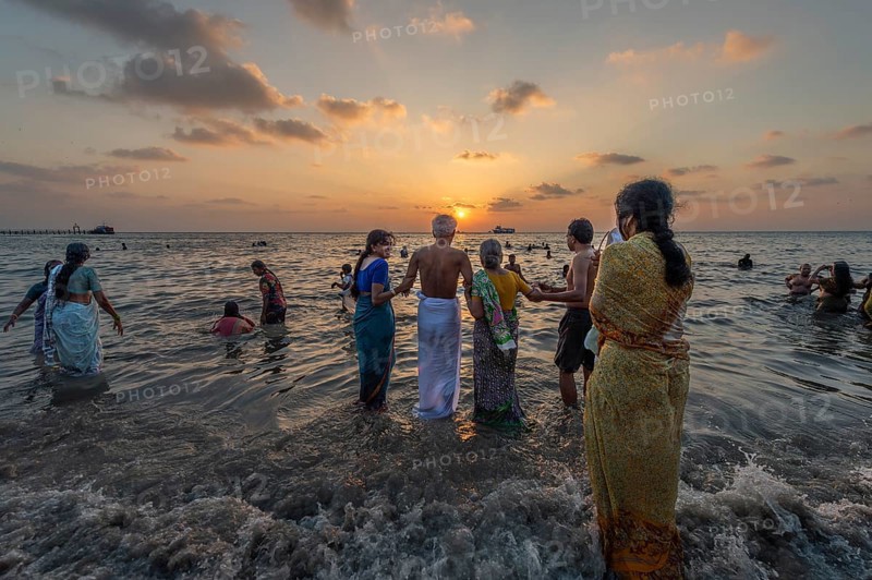 Hindu pilgrims take a holy dip in the sea at sunrise at Ghat Agni Theertham, Rameswaram or Rameshwaram, Pamban Island, Tamil Nadu, India, Asia
