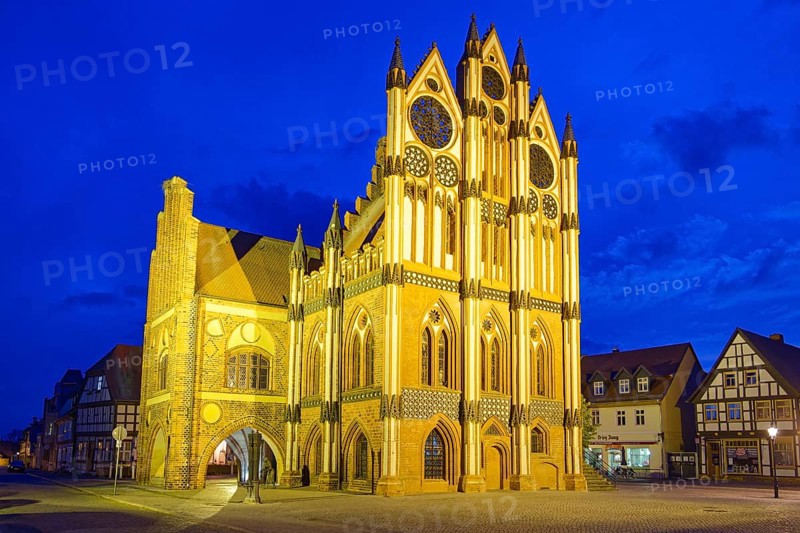 Tangermünde town hall on the market square, surrounded by half-timbered houses, illuminated in the evening. Old town centre of Tangermünde, Hanseatic town in the Altmark. Saxony-Anhalt, Germany, Europe