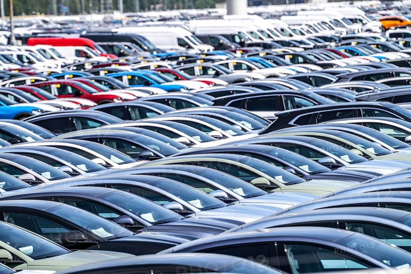 Storage area for new cars in the port of Vlissingen-Oost, vehicles are temporarily stored on over 100 hectares to ship them from Europe to the United Kingdom, Ford cars, others such as models from the Chinese car manufacturer BYD are delivered from here in Europe, wind farm, Netherlands