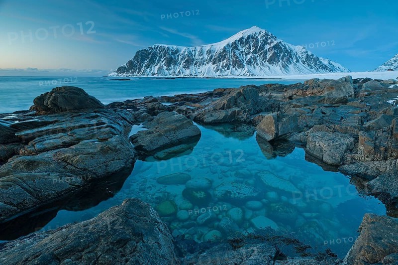 Long exposure, winter at Skagsanden, rocks washed over by the sea on the beach at Flakstad, Flakstadøy, Lofoten, Nordland, Norway, Europe