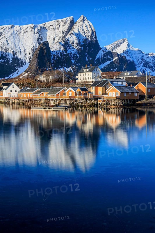 Wooden houses on a fjord off Bergen, morning light, reflection, winter, Reine, Moskenesoya, Lofoten, Norway, Europe