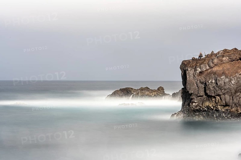 Angler on the beach and rocks, surf on Lanzarote, Spain, Europe