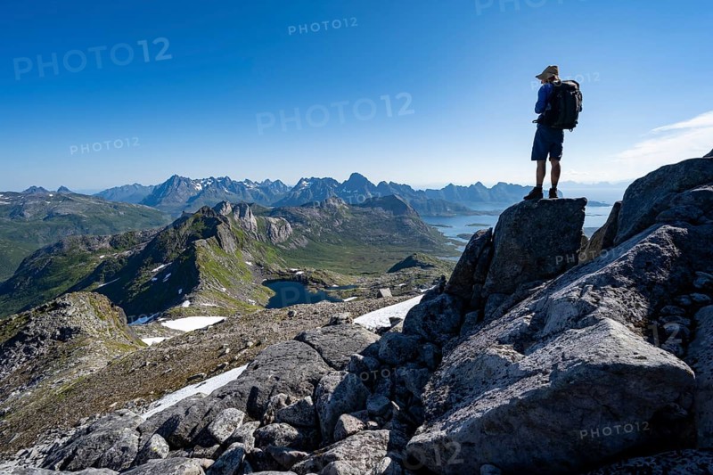 View of mountains and fjord landscape, mountain panorama, mountaineer at the summit of Rundfjellet, lake Hellskarvatnet, Svolvaer, Nordland, Norway, Europe