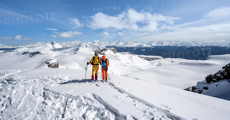 Couple, two ski tourers at the summit Wisshore with mountain panorama, snowy mountain landscape, Bernese Alps, Switzerland, Europe
