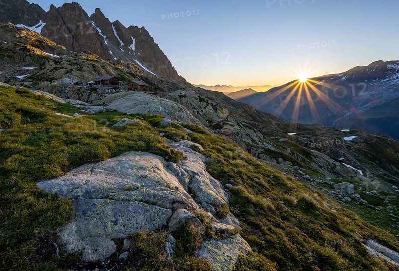 Morning atmosphere with sun star, mountain landscape at sunrise, mountain hut Refuge du Lac Blanc, Chamonix-Mont-Blanc, Haute-Savoie, France, Europe