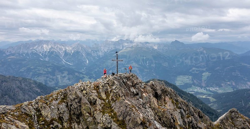 Aerial view, hiker on the Raudenspitze with summit cross, Carnic High Trail, Carnic Main Ridge, Carnic Alps, Carinthia, Austria, Europe